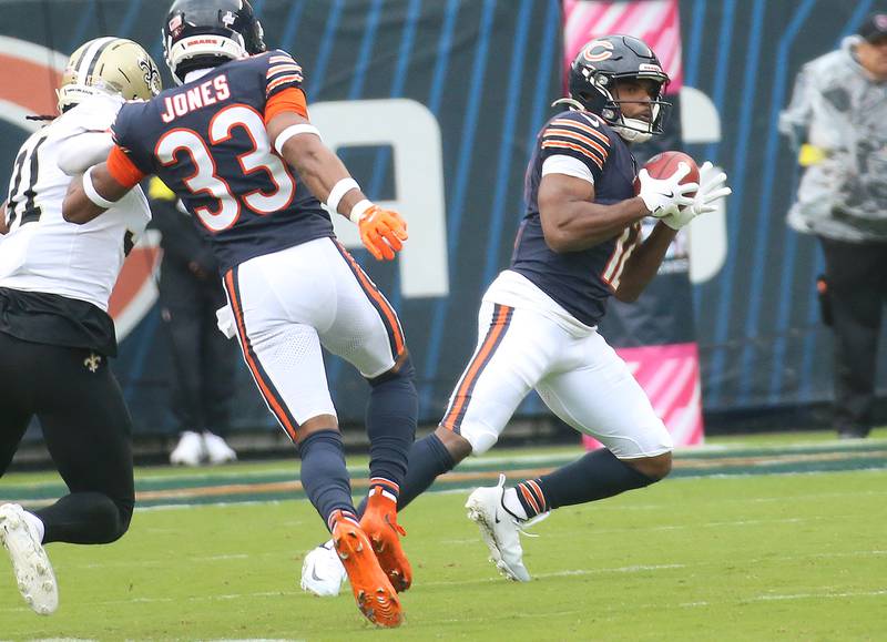 Chicago Bears wide receiver Devin Duvernay catches the ball on a return as teammate defensive back Jaylon Jones hold off New Orleans Saints defensive back Jordan Howden