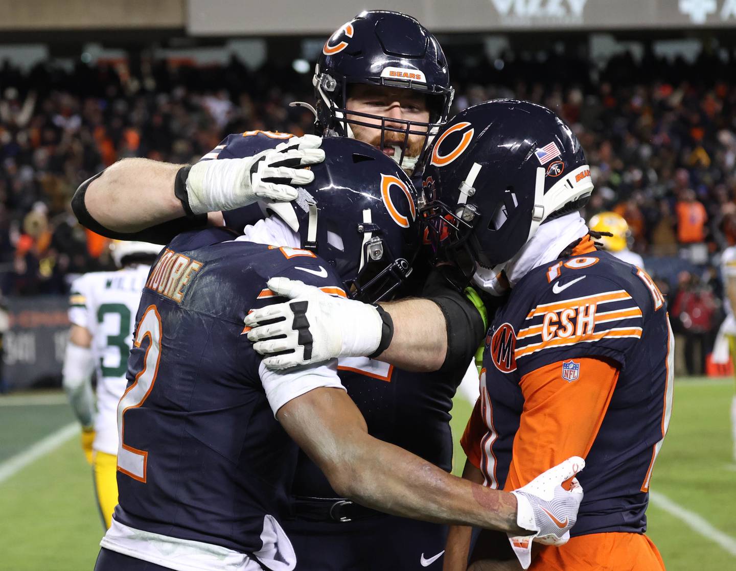 Chicago Bears wide receiver DJ Moore (left) celebrates his late go-ahead touchdown catch with guard Joe Thuney and wide receiver Luther Burden III (right) during their NFL Wild Card game Saturday, Jan. 10, 2026, at Soldier Field in Chicago.