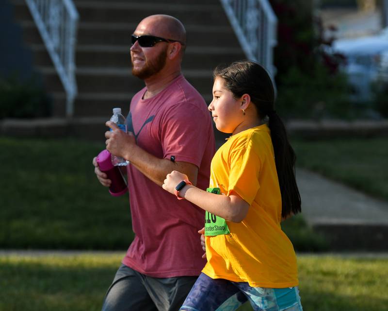 Carlos and his daughter Zimena Vargas, 10 years old, of Lions Township complete the 1 mile run together during the Leadershop event held on Friday June 9, 2023.