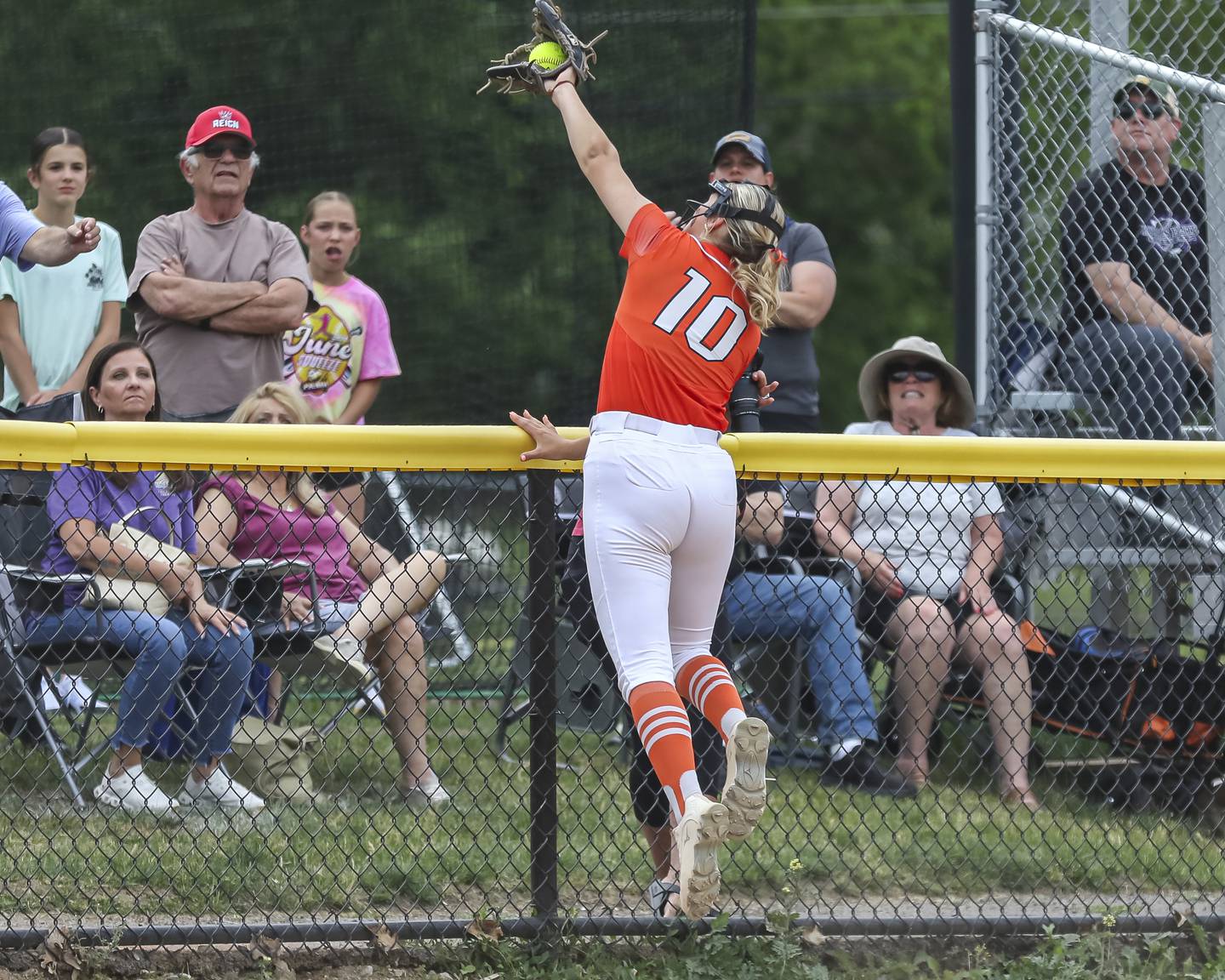 Lincoln-Way West's Molly Finn (10) catches a foul ball at the third base side fence during Class 4A Lockport sectional softball game between Lincoln-Way Central at Lincoln-Way West on Tuesday, June 3, 2025 in Lockport.