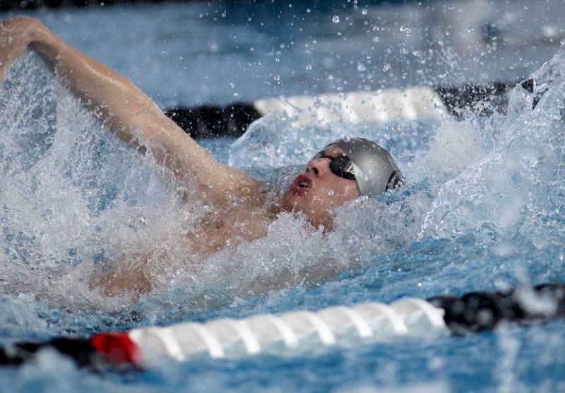 Plainfield’s Jack Burke swims the backstroke leg of the consolation heat of the 200-yard medley relay during the IHSA Boys Swimming and Diving Championships at FMC Natatorium in Westmont on Saturday, Feb. 26. 2022.