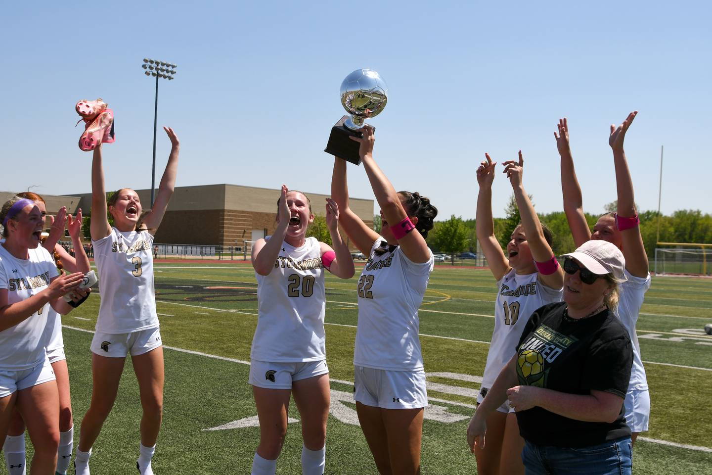 Sycamore’s Hailey Clawson (22) lifts up the trophy after the game against DeKalb on Saturday May 10, 2025, held at DeKalb High School.