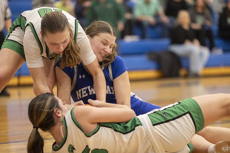 Newman’s Veronica Haley and Wethersfield grapple for a loose ball Thursday, Feb. 26, 2026, in the Class 1A sectional semifinal at Eastland.