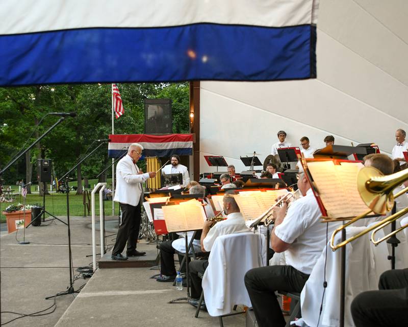 Kirk Lundbeck conducts the DeKalb Municipal Band during its annual Independence Day concert at Hopkins Park in DeKalb on Monday July 4, 2022.