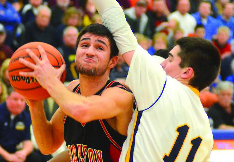 Forreston's Wyatt Kerchner is guarded by Aquin's Aiden Chang. Chang defensively shut down Kerchner for most of the game by holding Kerchner to 5 points. Photo by Chris Johnson