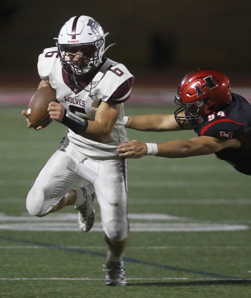 Prairie Ridge's Luke Vanderwiel runs with the football as Huntley's Ethan Albertson tries to grab Vanderwiel during a Fox Valley Conference football game on Friday, Sept. 20, 2024, at Huntley High School.