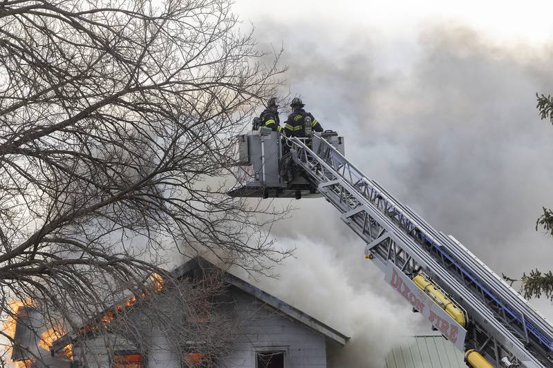 Firefighters battle a house fire Monday, April 14, 2025, at 1308 Harmon Road.