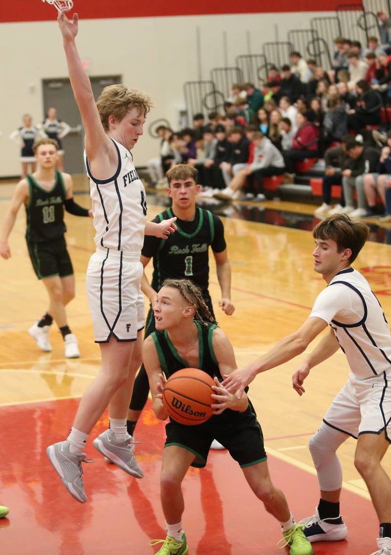 Rock Falls's Nehemiah Menendez looks to pass as Fieldcrest's Jordan Heider and Connor Reichman defend during the 49th annual Colmone Classic on Saturday, Dec. 9, 2023 at Hall High School.