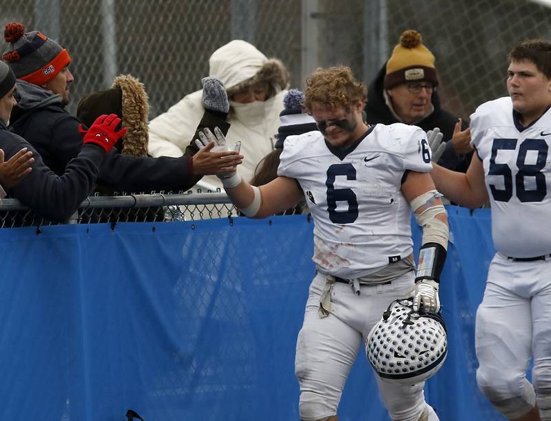 Cary-Grove's Charles Ciske leads his team as they high five the fans after losing to Geneva in an IHSA Class 6A semifinal football game on Saturday, Nov. 23, 2024, at Geneva High School.