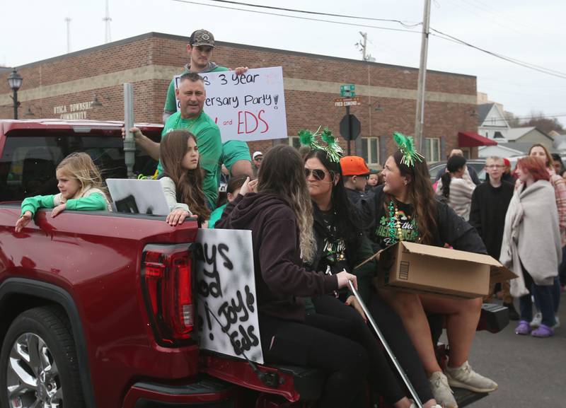 Crews ride the Joy and Ed's float during the St. Patrick's Day parade on Saturday, March 15, 2025 downtown Utica.