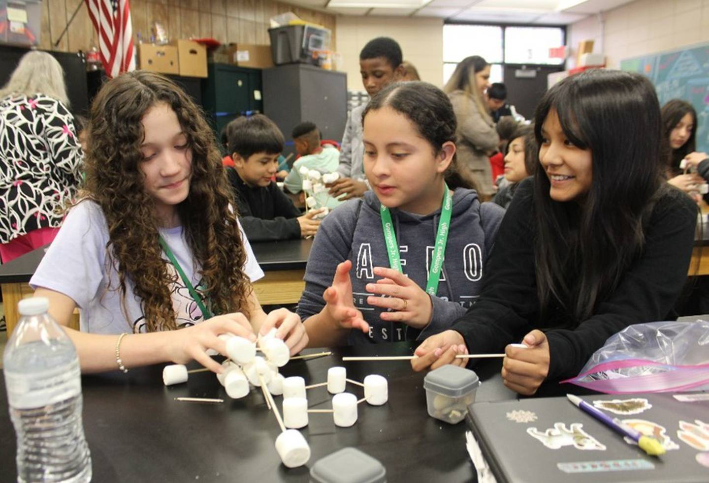 Gompers Junior High School students Valeska Castellano, Ericka Vasquez Henriquez, and Sofia Perez Camargo discuss their ideas to build a strong water tower.