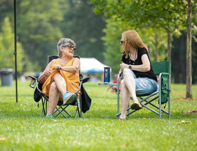 Linda Mac, left, and Janet Schuurman sit and watch the band Zazz perform during the Voyage en France Fest at Cantigny in Wheaton on Sunday, July 16, 2023.