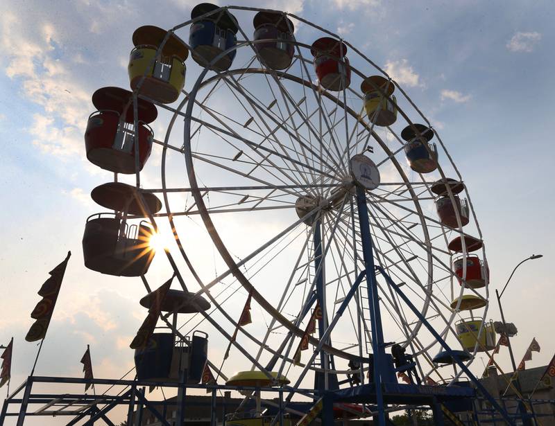The sun shines through a 50-foot tall Ferris wheel during the Celebrate La Salle Festival on Friday, June 23, 2023 downtown La Salle. The wheel is in it's second year of operation and costs $600,000.