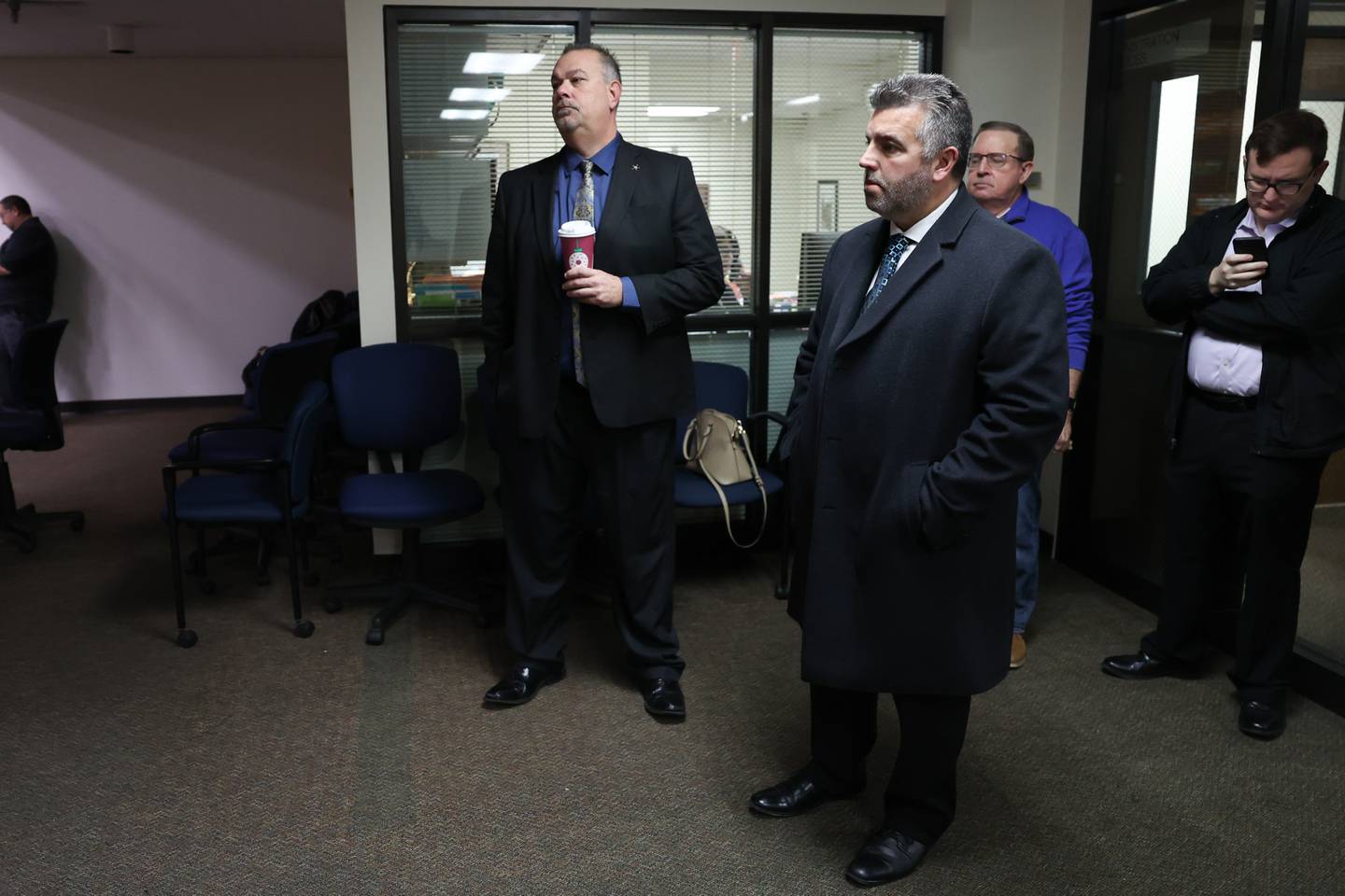 Will County Sheriff Mike Kelley, left, watches as mail in ballots are counted on Tuesday at the Will County Office Building.