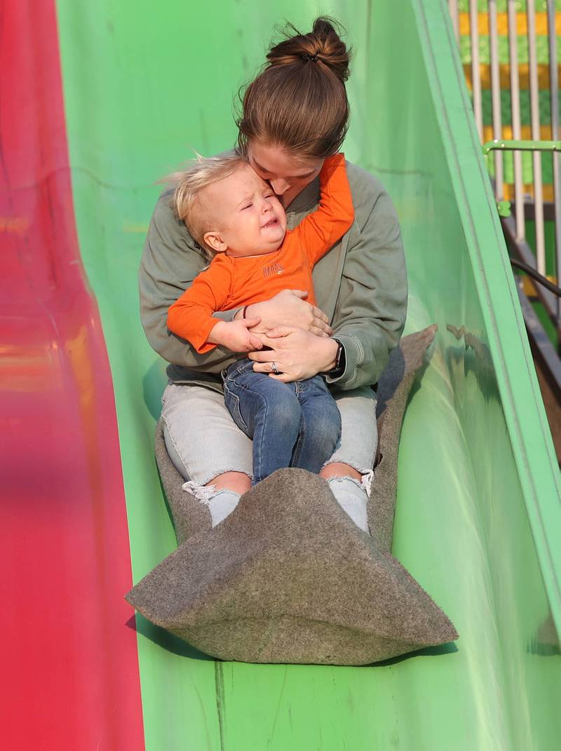 Joseph Schilling, 1, from Albany, isn’t sure about the slide as he holds on to his mom Ashley on the way down during Genoa Days, Wednesday, June 7, 2023, in downtown Genoa. The festival continues through Saturday.