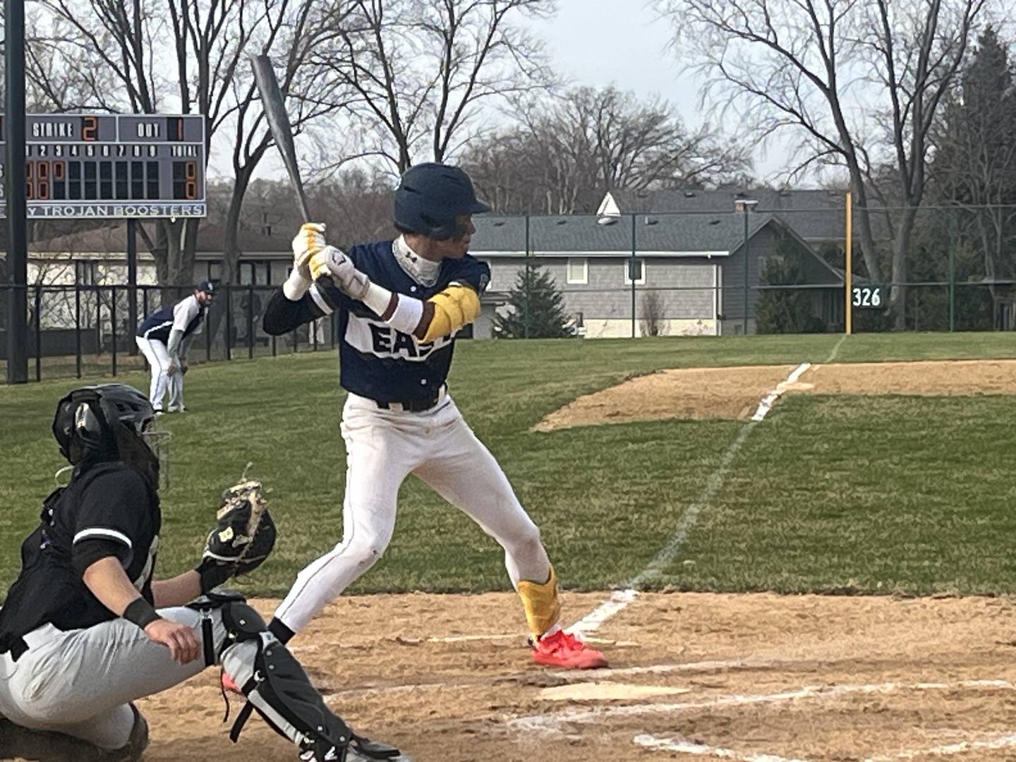 Oswego East's Jacsen Tucker takes a pitch during Tuesday's game at Downers Grove North.