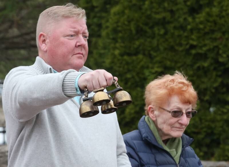 Utica trustee John Schweickert rings a bell in honor of the eight victims who passed away during the 20th anniversary of the tornado at the memorial on Saturday, April 20, 2024 in Utica.