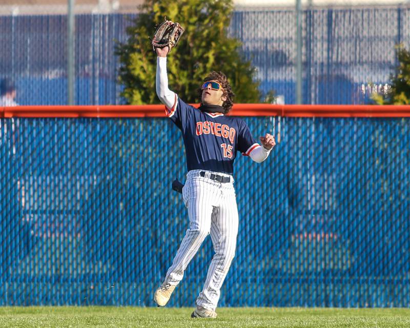 Oswego's Donny Williams (15) makes a catch in the outfield during baseball game between Plainfield South at Oswego on Monday, April 14, 2025 in Oswego.