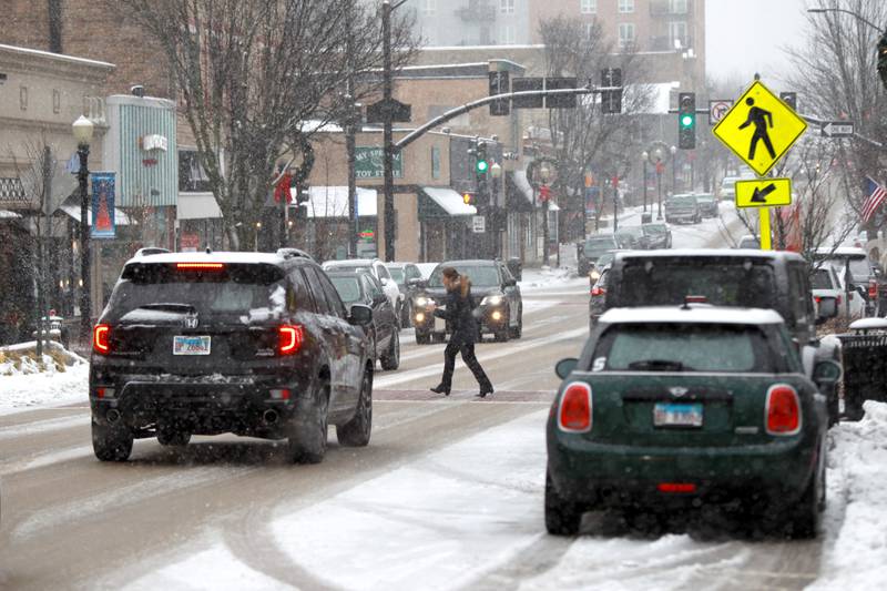 Snow falls in downtown Downers Grove on Tuesday, Jan. 9, 2024.