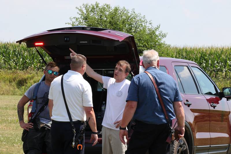 Cortland and DeKalb firefighters talk at the scene of a plane crash Thursday, July 27, 2023, behind a business at 260 West Lincoln Highway in Cortland.