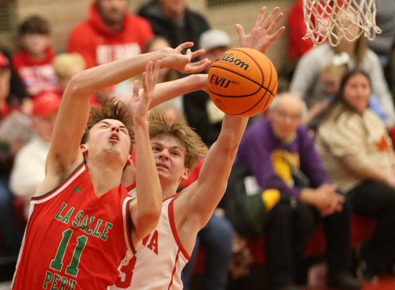 L-P's Jameson Hill has his shot batted away by Ottawa's Owen Sanders on Friday, Jan. 10, 2024 in Kingman Gym at Ottawa High School.