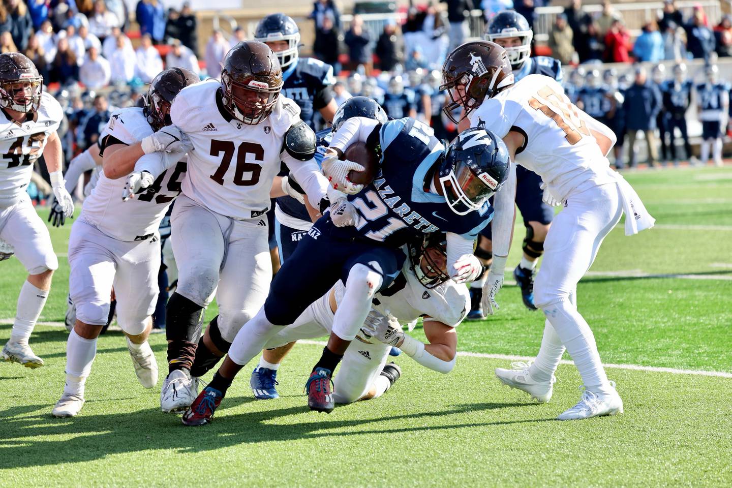 Joliet Catholic defensive lineman Dillan Johnson (76) zeroes in on making a tackle in the Class 5A State Championship game.