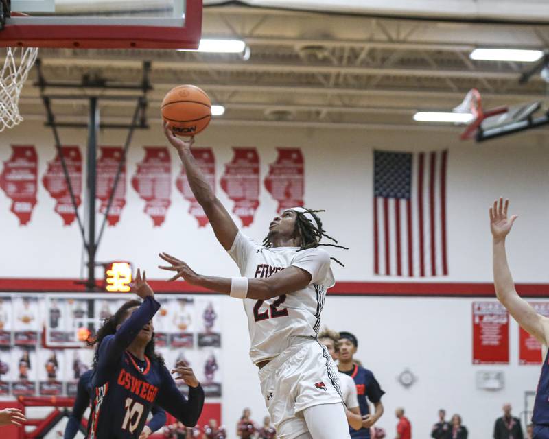 Yorkville's Braydon Porter (22) leans in with a shot attempt during their basketball game between Oswego at Yorkville Friday, Dec 12, 2025 in Yorkville.