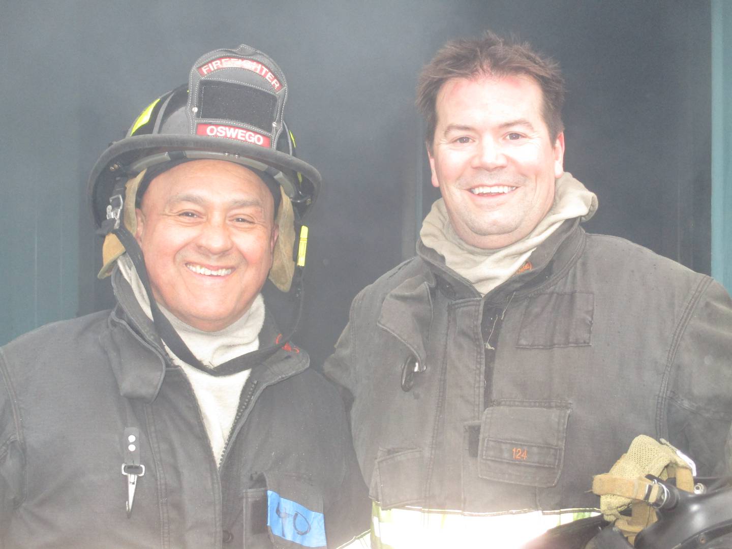 Kendall County Board members Ruben Rodriguez, left, and Scott Gengler were all smiles after emerging from a smoke-filled structure during a training exercise with the Oswego Fire Protection District. (Mark Foster -- mfoster@shawmedia.com)