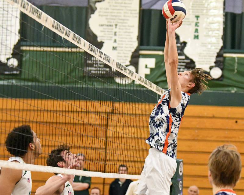 Oak Park-River Forest's Quinn Bozarth (8) sets the ball during the game on Tuesday April 16, 2024, while traveling to take on Glenbard West High School.