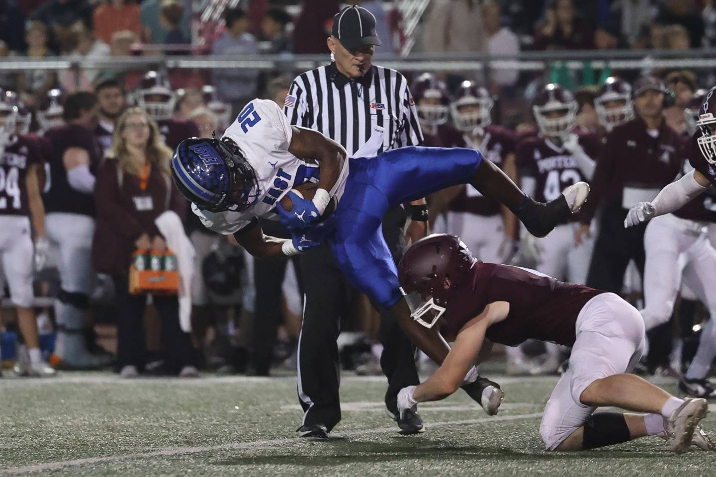 Lincoln-Way East’s Zion Gist leaps a tackle for extra yards on a run against Lockport on Friday, Sept. 29, 2023 in Lockport.