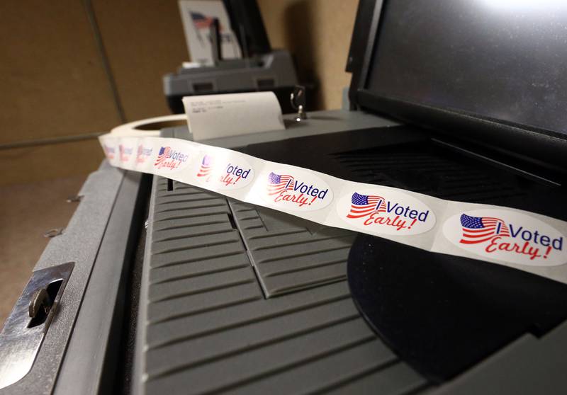 I voted early stickers are placed on a ballot machine in the basement at the La Salle County Courthouse.
