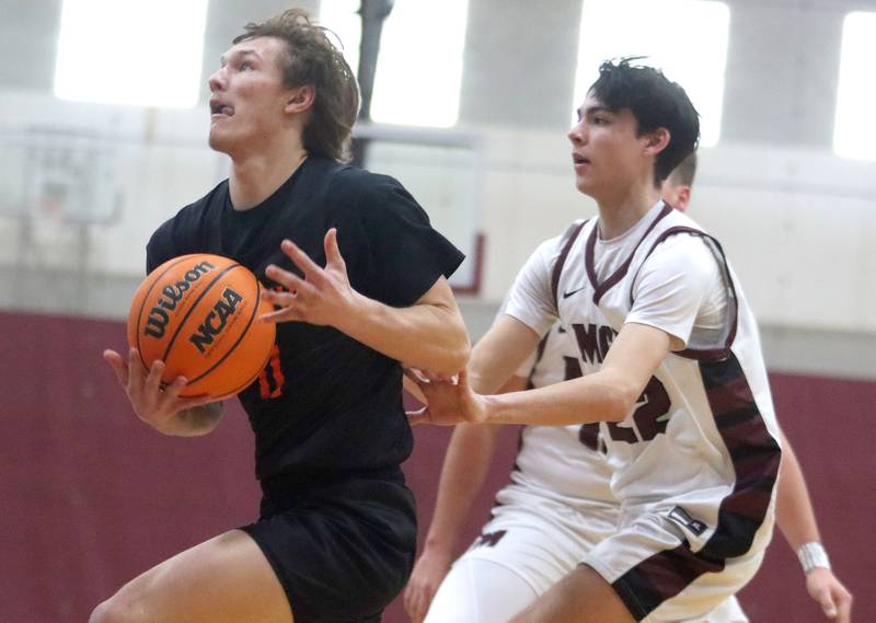 Sandwich’s Nicholas Michalek works under the net in varsity boys basketball action on Saturday, Jan..24, 2025, at Marengo High School in Marengo.