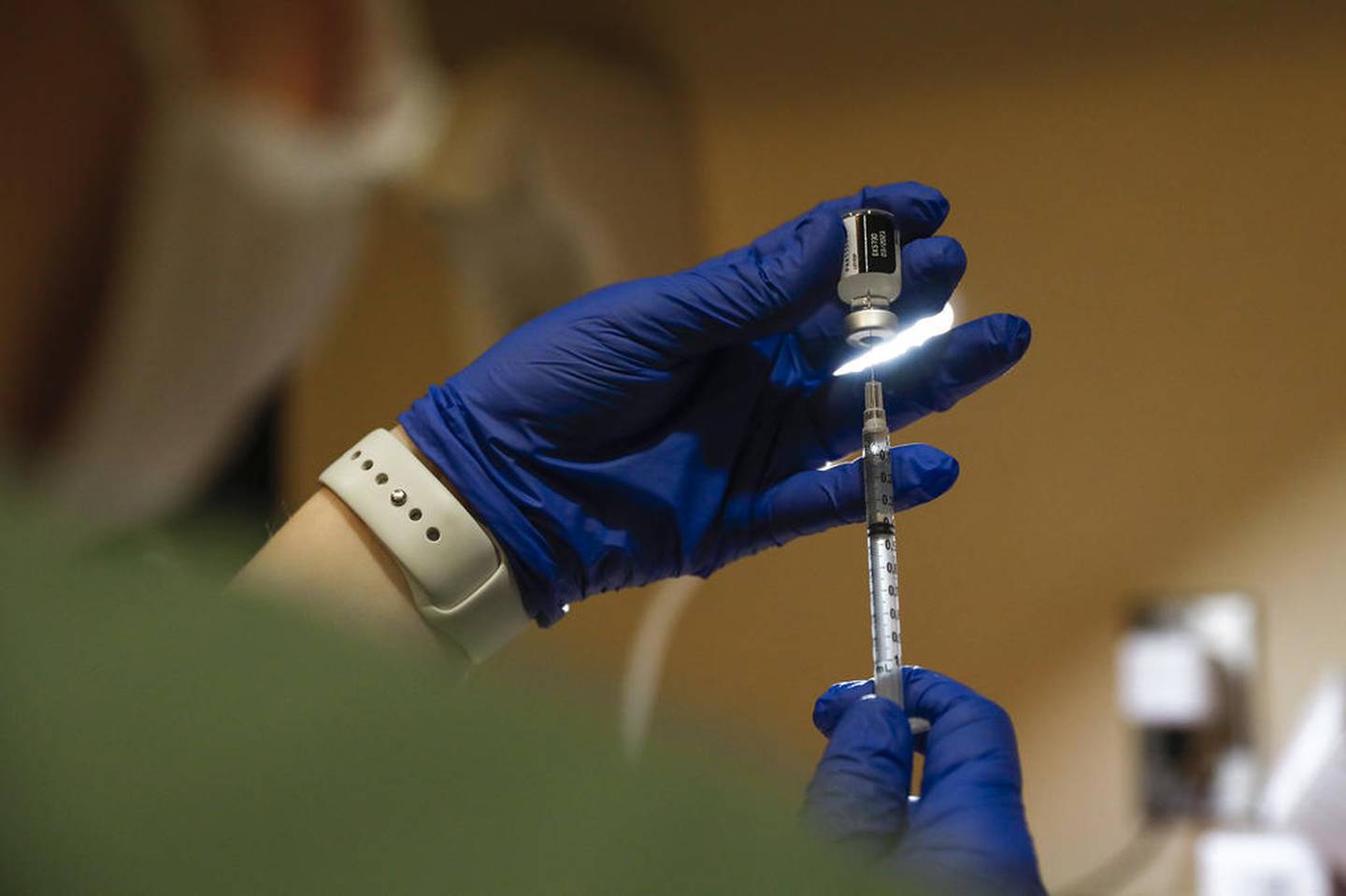 Pharmacy Manager Nicole Costa prepares the first dose of Pfizer’s COVID-19 vaccine to be administered on Wednesday, Dec. 16, 2020, at AMITA Health Saint Joseph Medical Center in Joliet, Ill. Health care workers from AMITA Health Saint Joseph Medical Center received the first round of vaccinations in Will County.