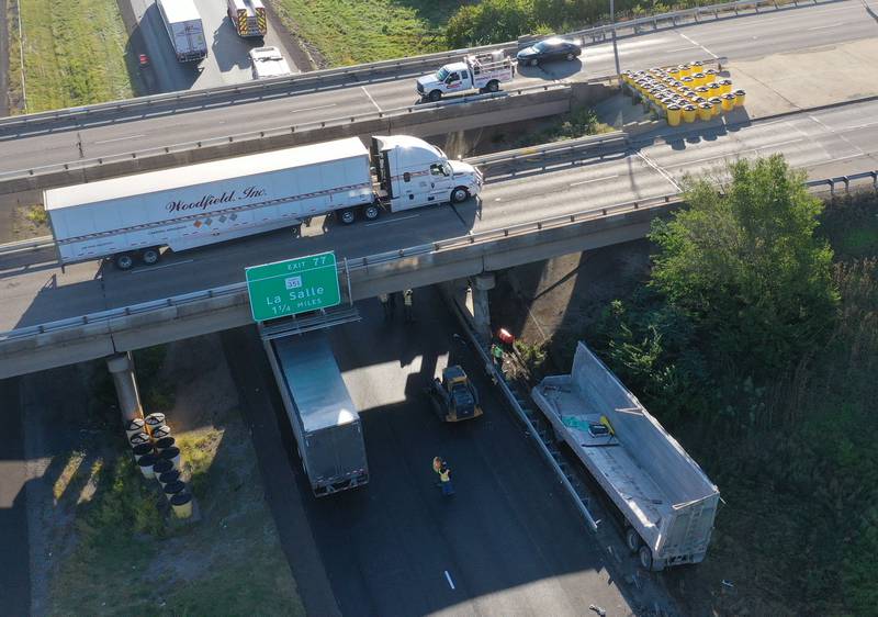 An aerial view showing emergency crews working the scene of a semi truck that struck the overpass of Illinois Route 251 and Interstate I-80 on Friday, Sept. 26, 2025 in Peru. The driver of the semi had to be extricated. Illinois State Police, Peru Fire and EMS,  Senica Towing and Illinois Department of Transportation were all on the scene. The incident happened in a construction zone on Interstate I-80 shortly after 7:15a.m.