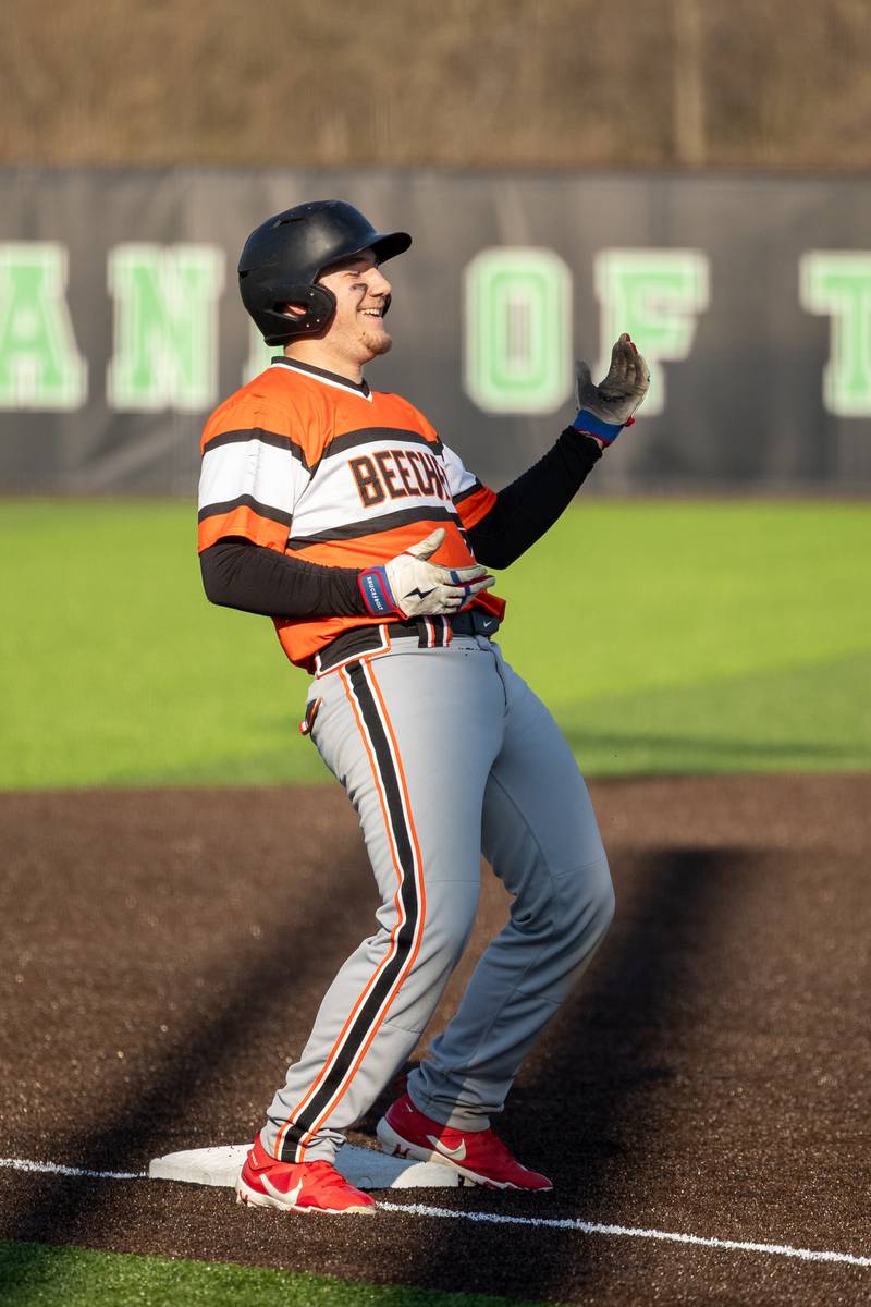 Steven Fezler (88) of Beecher celebrates by “shimmying” on third base on Friday, April 11, 2025 at Seneca High School in Seneca.