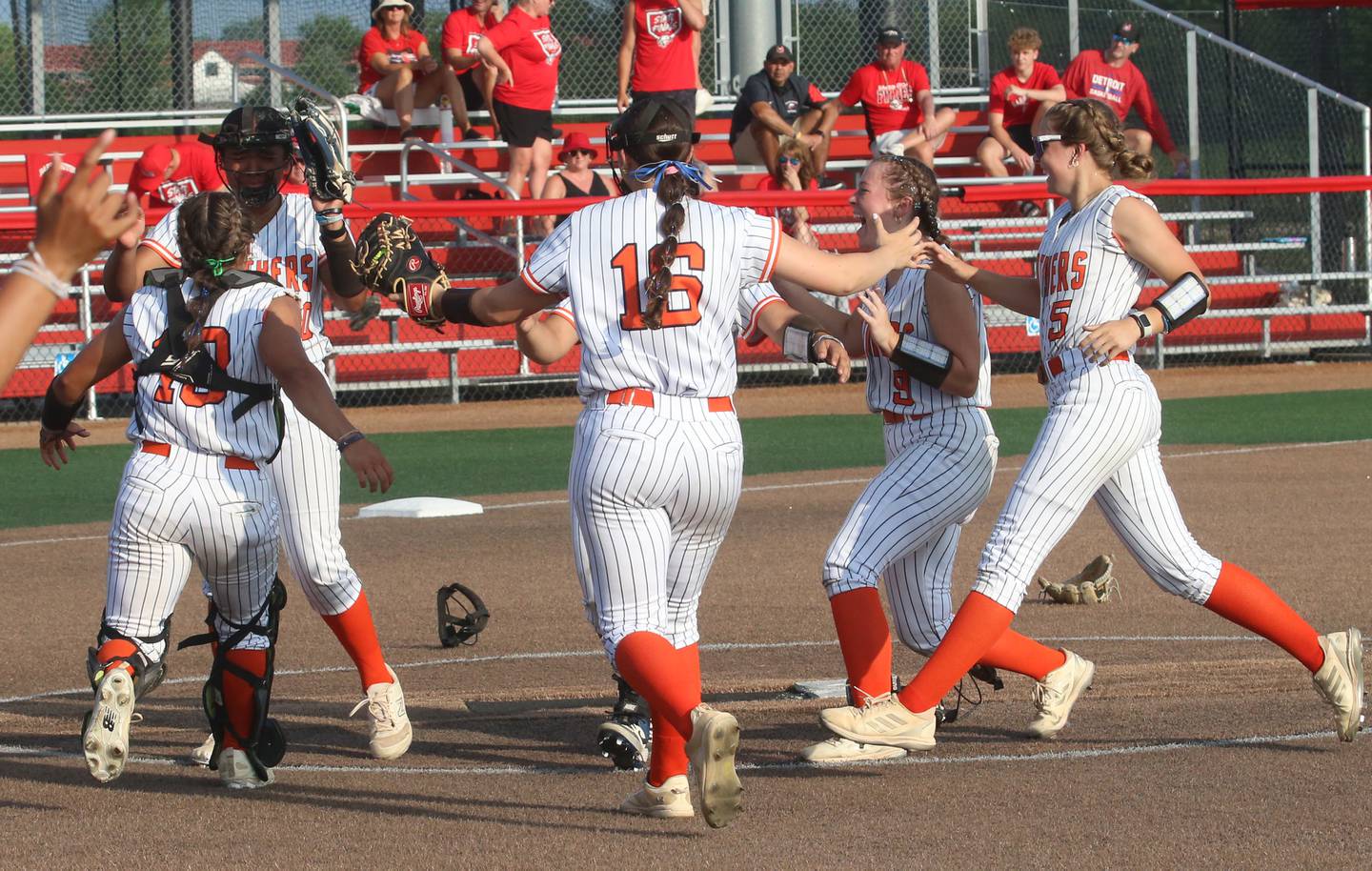 Members of the Oswego softball race to the mound to celebrate winning the Class 4A championship after defeating Barrington on Saturday, June 14, 2025 at the Louisville Slugger Sports Complex in Peoria.