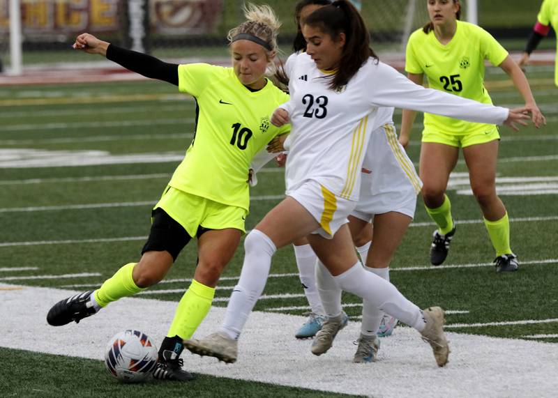 Richmond-Burton's Madelyn Seyller kicks the ball as she is defended by Harvard's Julie Silva during the Kishwaukee River Conference Girls Soccer Tournament Championship Match on Wednesday, May 7, 2025, at HRichmond-Burton High School in Richmond.