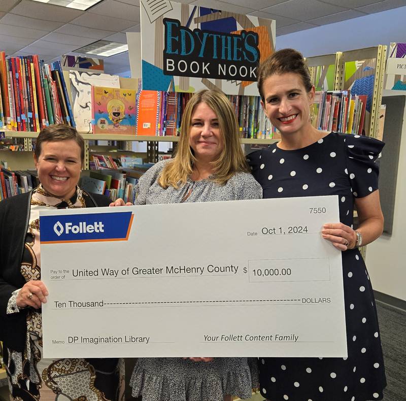 Sarah Fisher of Follett Content Solutions, left, Jamie Maravich of United Way for Greater McHenry County and Follett Content Solutions CEO Britten Follett celebrate with a $10,000 donation to United Way to help fund the Dolly Parton Imagination Library program in the area.