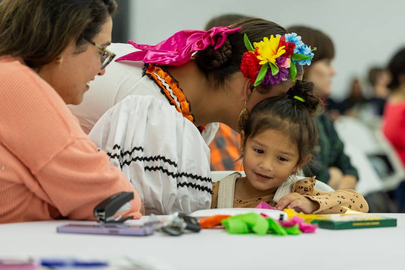 (from left) Arianna Quintana whispers to Clarissa Bugarin at the 'Where Our Paths Meet' screening event on Sunday, Sep 7, 2025 at Diaz Banquet Center in Mendota.