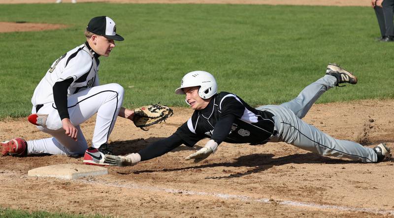 Kaneland's Caleb Cornell gets back just ahead of the tag of Sycamore's Noah Neece on a pickoff attempt Tuesday, April 28, 2026, during their game at the Sycamore Community Sports Complex.