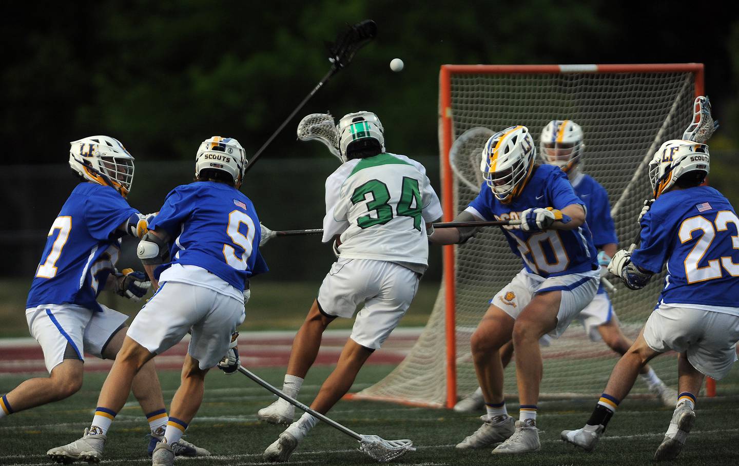 York's Charlie Toreja moves to score as Lake Forest's defense surrounds him but fails to stop his shot in the first period at the boys lacrosse state semifinals at Robert Morris University football field in Arlington Heights on Thursday