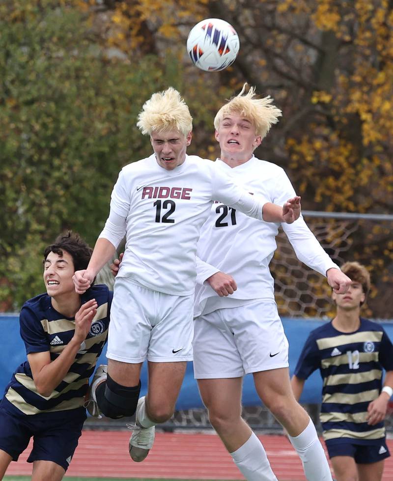 Prairie Ridge's Samuel Kirk (left) and Nicolas Flaugher head the ball away from Lemont's Luciano Mancini Saturday, Nov. 9, 2024, during their Class 2A state third place game at Hoffman Estates High School.