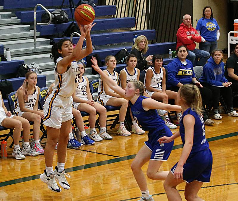 Aurora Central Catholic's Sofia Corral (25) shoots a three-point basket over Newark's Tess Carlson (12) in the Tim Humes Breakout Tournament on Friday, Nov. 18, 2022 in Somonauk.