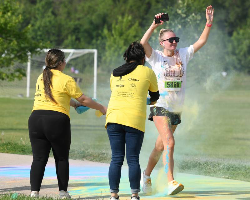 Samantha Koehler of Sycamore gets sprayed with color powder on Saturday, June 7, 2025, during the CASA DeKalb County 5K Color Run held at the Sycamore Middle School.