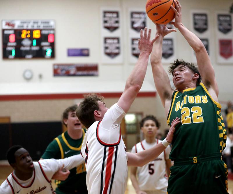 Crystal Lake South's Nick Stowasser grabs a rebound over Huntley's Aidan Gibbs during a Fox Valley Conference boys basketball game on Wednesday, Dec. 10, 2025, at Huntley High School.