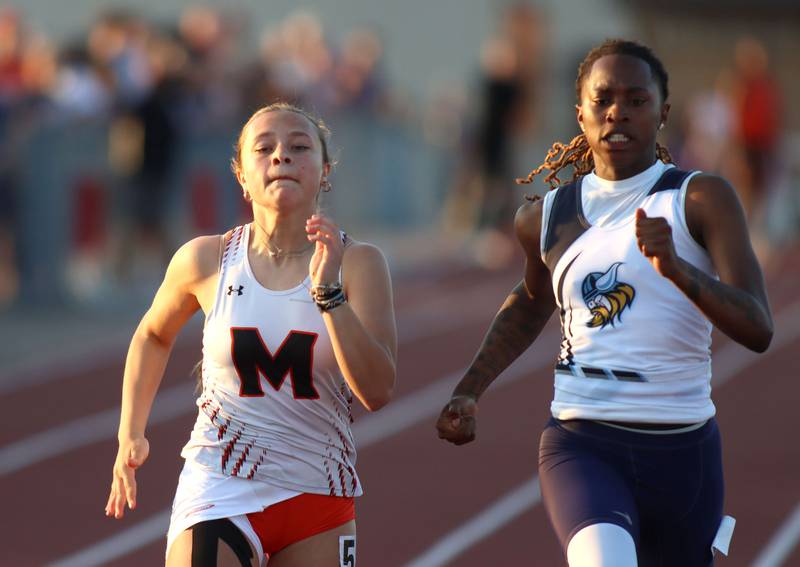 McHenry’s Addison Hoffmann, left, and Rockford Guilford’s Zariah Burnett compete in the 100-meter dash in IHSA Class 3A Girls Sectional Track and Field Meet action at Red Raider Stadium on the campus of Huntley High School in Huntley on Wednesday, May 14, 2025.