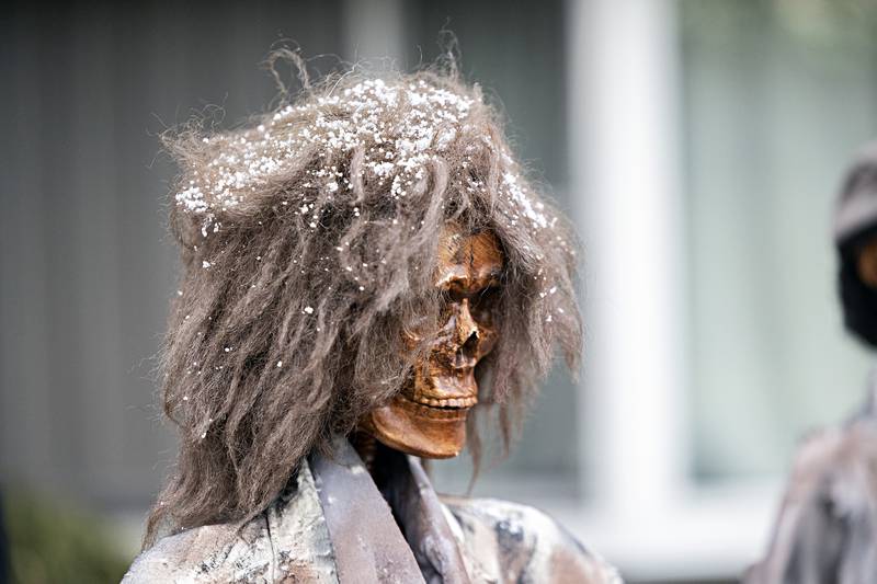 An afternoon snow sits on one of the creepy decorations at Dave and Mary Lally’s home Tuesday, Oct. 31, 2023.