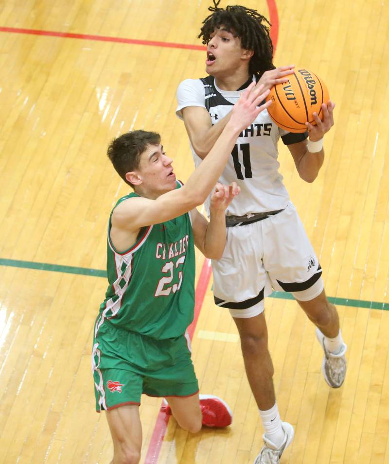 Kaneland's Evan Frieders eyes the hoop as L-P's Nick Olivero defends on Friday, Jan. 31, 2025 in Sellett Gymnasium at L-P High School.