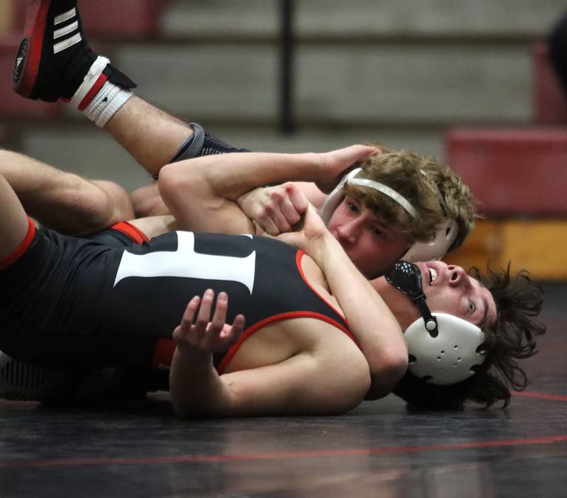 Huntley’s Cameron Abordo, front, battles Prairie Ridge’s  Jake Lowitzki at 120 pounds in varsity wrestling on Thursday, Jan. 23, 2025, at Huntley High School in Huntley.