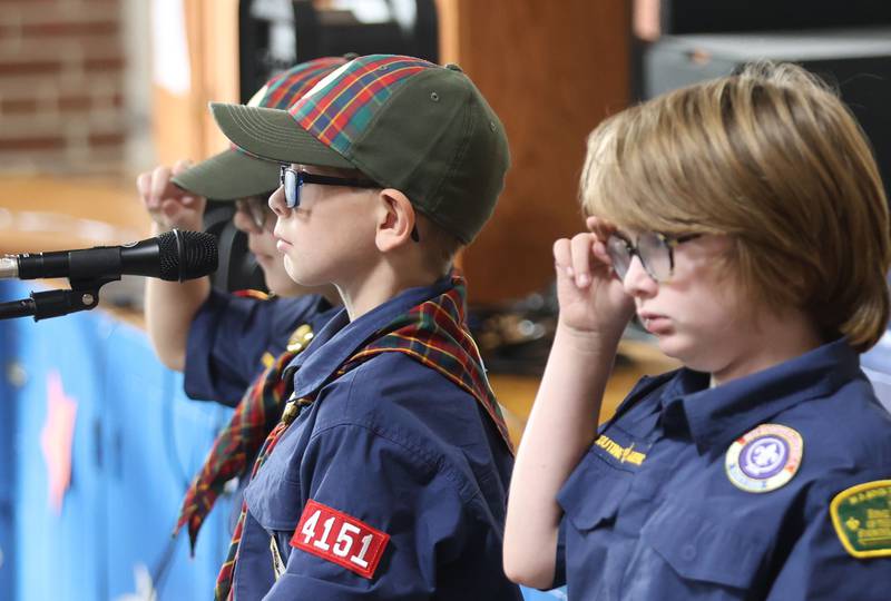 Cub Scouts Elliott Newton, Levi Ackerman and Henry Cofoid salute the American Flag after presenting the colors during the Veterans Day program at Lincoln School on Tuesday, Nov. 11, 2025 in Princeton.